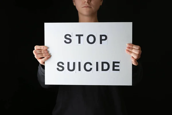 Woman Holding Paper Sheet Text Stop Suicide Dark Background — Stockfoto