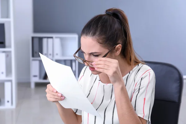 Businesswoman with bad sight working in office