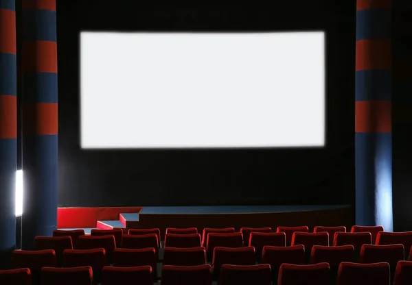 Empty cinema with large screen and comfortable chairs