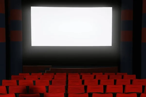 Empty cinema with large screen and comfortable chairs