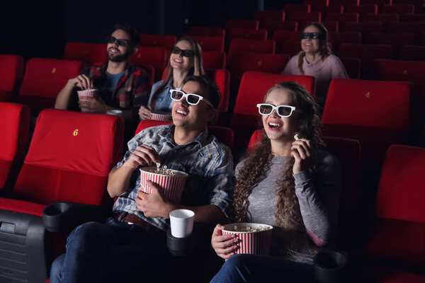 Young couple watching movie in cinema