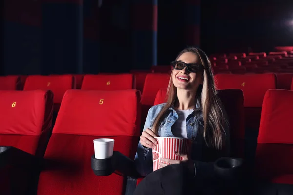 Young woman watching movie in cinema