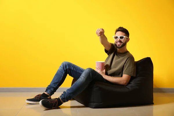 Young Man Popcorn Watching Movie While Sitting Color Wall — Stock Photo, Image