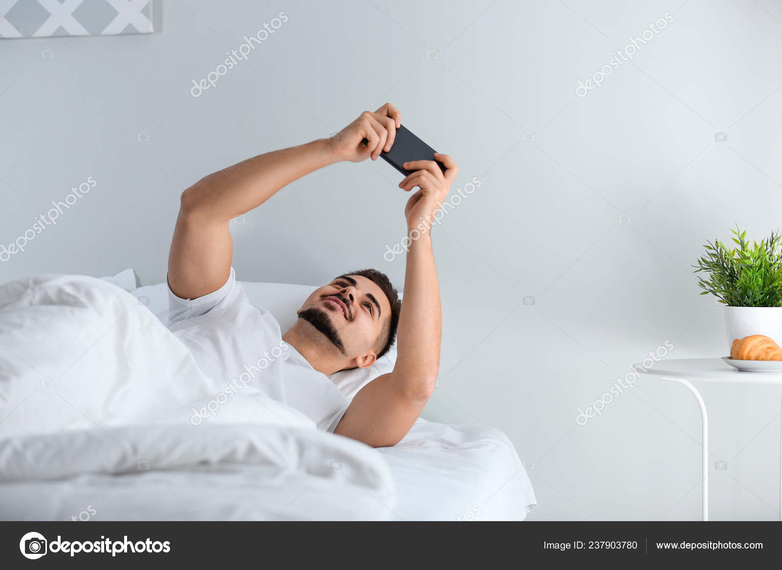 Young Man Playing Game Smartphone Bed Stock Photo C Serezniy 237903780 young man playing game smartphone bed stock photo c serezniy 237903780