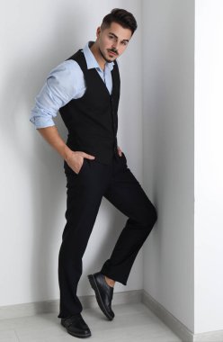 Beyaz duvarının yakınında şık yakışıklı adam