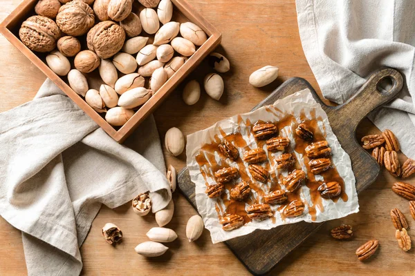 Tasty pecan nuts on wooden table