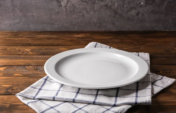 Clean empty plate on wooden table