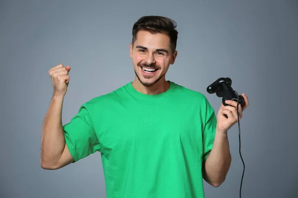 Happy Young Man Winning Video Game Grey Background — Stock Photo, Image