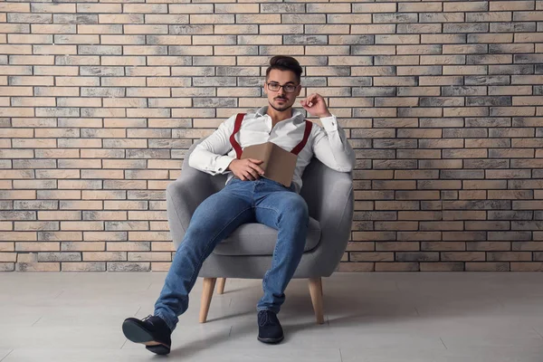 Stylish Handsome Man Book Sitting Armchair Brick Wall — Stock Photo, Image