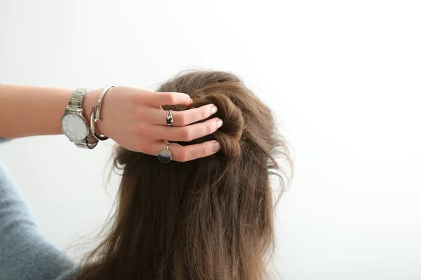 Beautiful Young Woman Stylish Bijouterie Doing Her Hair White Background — Zdjęcie stockowe