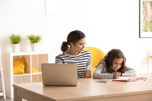 stock image Busy mother with daughter working at home