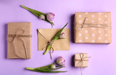 Composition with beautiful gift boxes and flowers on color background