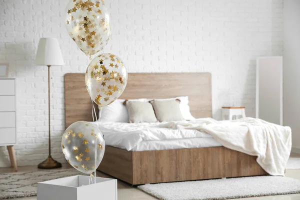 Air balloons in light modern bedroom