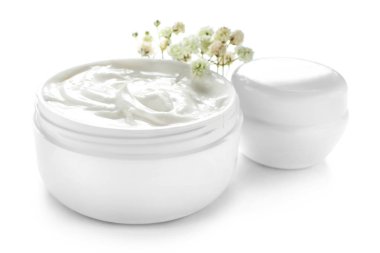 Jars of cream on white background