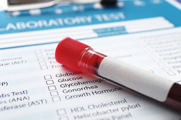 Blood sample on document with result of analyses, closeup