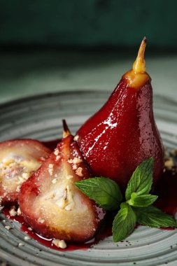Sweet pears stewed in red wine on plate