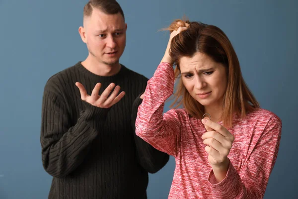 Unhappy couple on color background. Concept of divorce