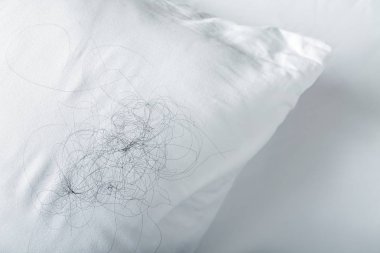 Soft pillow with fallen down hair clipart