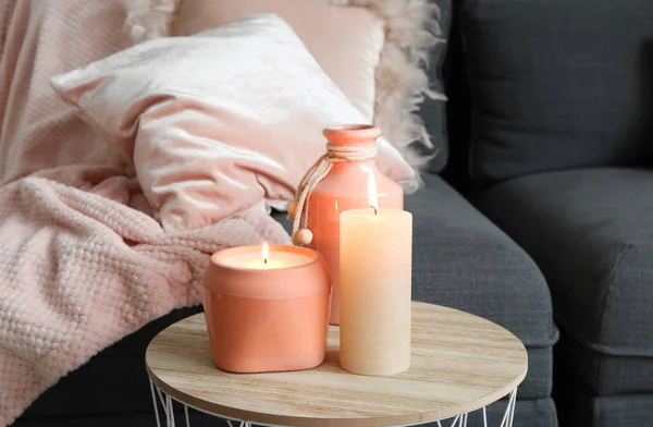 Beautiful burning candles on table in room