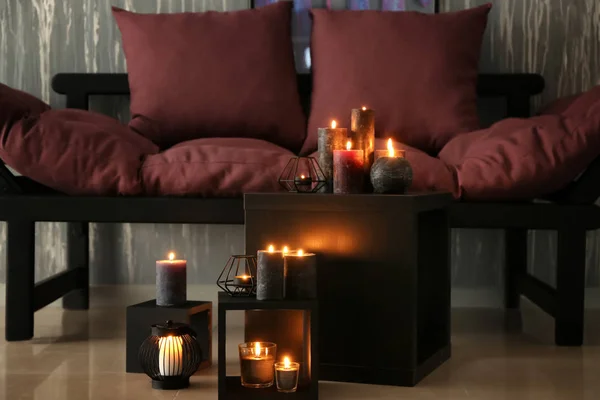 Beautiful burning candles in room