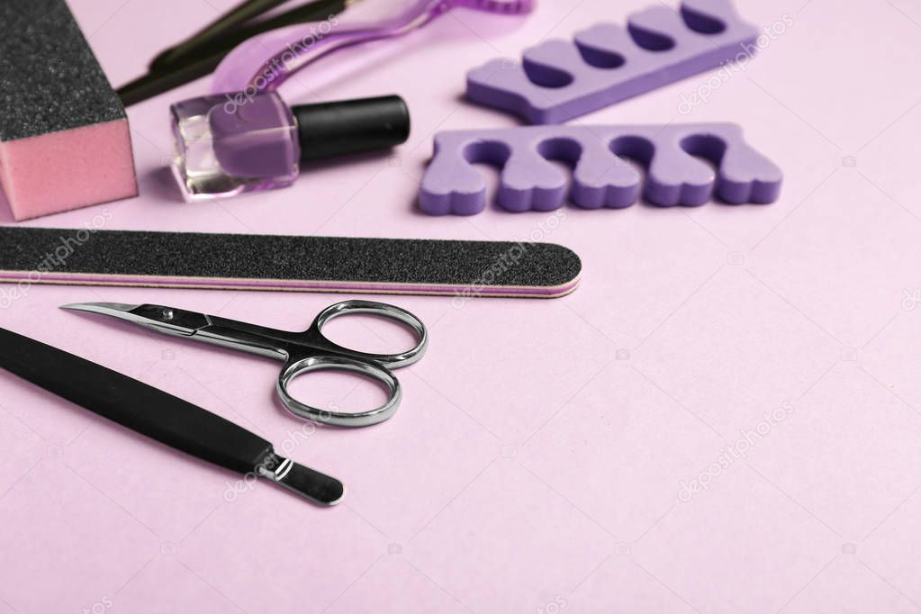 Set of pedicure tools on color background