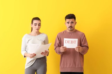 Endişeli genç çift renk arka plan üzerinde borç