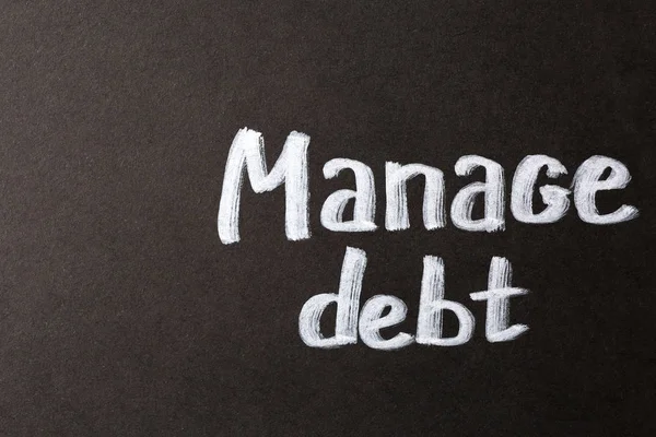 Text MANAGE DEBT on dark background