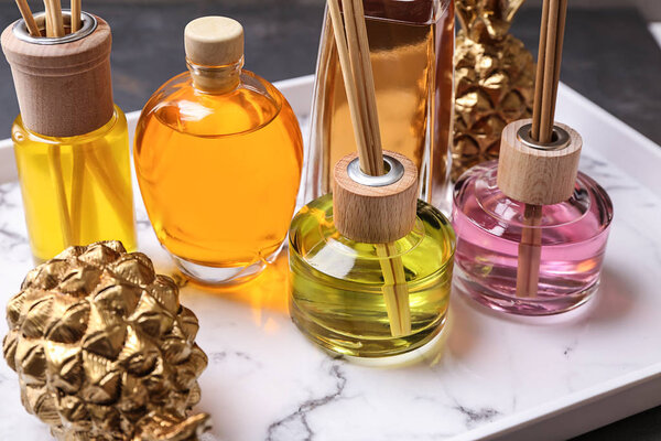 Tray with different reed diffusers on table