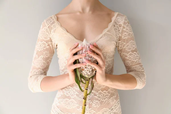 Young Woman Holding Tropical Flower Light Background — Stock Photo, Image