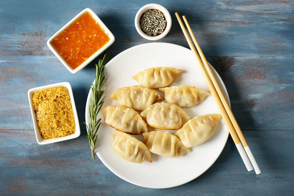 Plate Tasty Japanese Gyoza Sauces Wooden Table — Stock Photo, Image