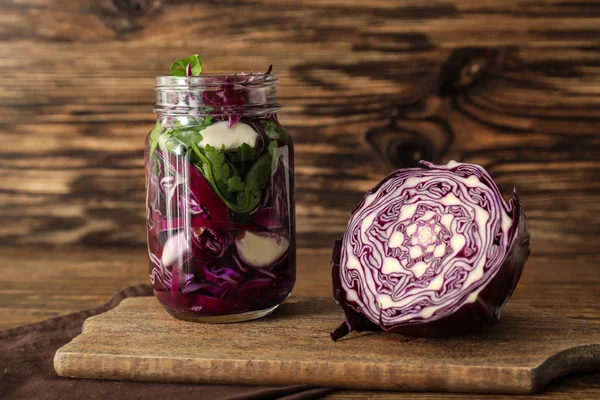 Glass jar with fermented cabbage and garlic on wooden table — Stock Image Glass Jar Fermented Cabbage Garlic Wooden Table Stock Image