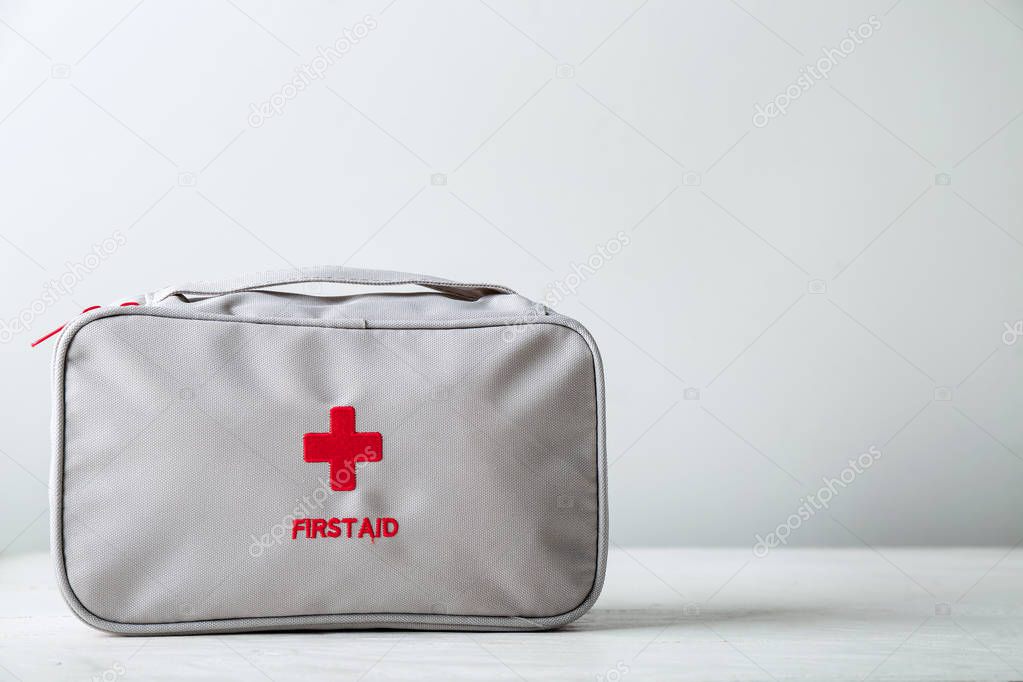 First aid kit on white table