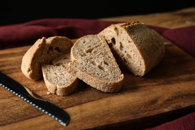 Taze ekmek ahşap tahta üzerinde bıçak ile kesme