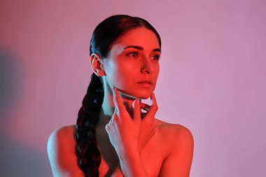 Renkli arka planda güzel bir genç kadının tonlu portresi.