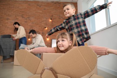 Taşınma günü üzerinde karton kutu ile oynayan çocuklar