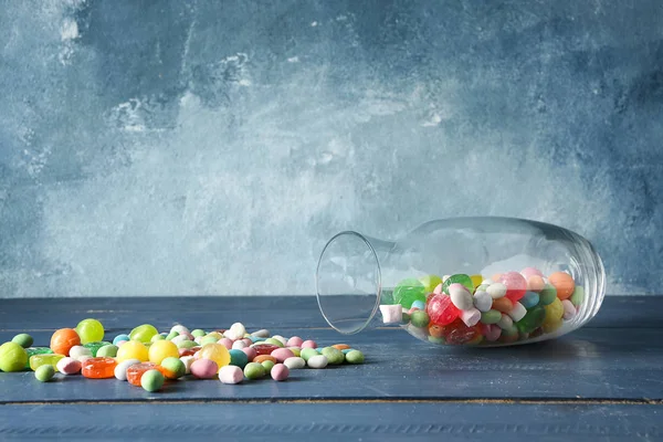 Overturned Glass Vase Candies Wooden Table — Stock Photo, Image