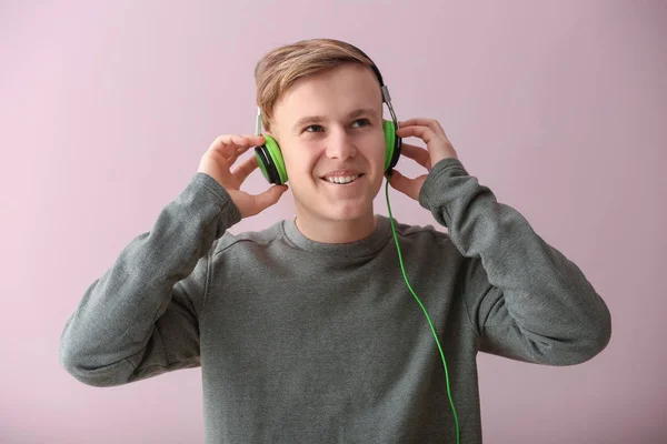 Красивый Молодой Человек Слушает Музыку Цветном Фоне — стоковое фото
