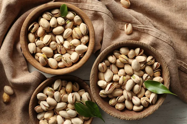 Wooden Plates Tasty Pistachio Nuts White Table — Stock Photo, Image