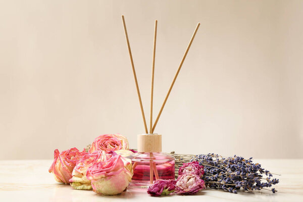 Reed diffuser and dry flowers on table