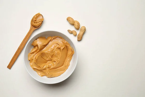 Bowl Spoon Tasty Peanut Butter Light Background — Stock Photo, Image