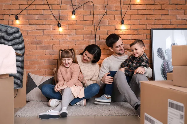 Family with cardboard boxes after moving into new house