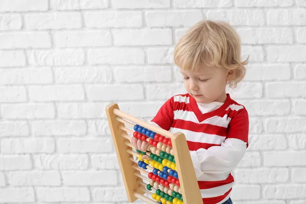 Portrait Cute Little Boy Abacus White Brick Background — Stock Photo, Image