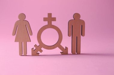 Female and male figures with symbol of transgender on color background clipart