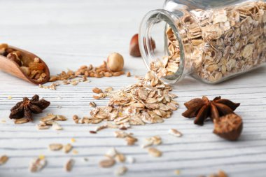 Yulaf gevreği beyaz masada devrilmiş kavanozu