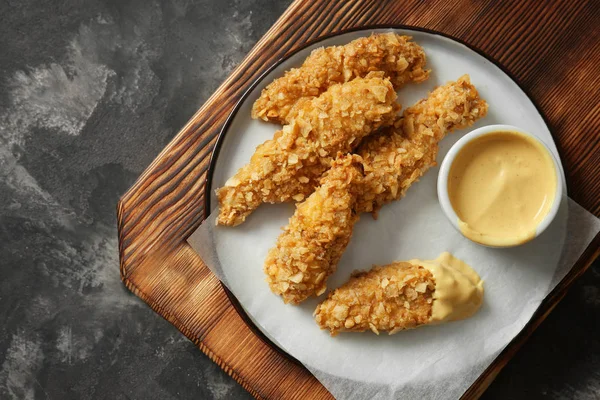 Wooden Board Tasty Nuggets Sauce Grey Table — Stock Photo, Image