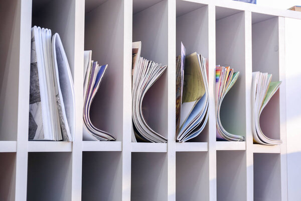 Many magazines on shelves in modern library