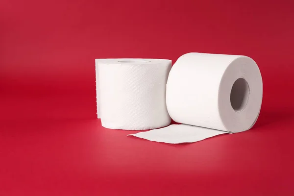 Rolls of toilet paper on color background