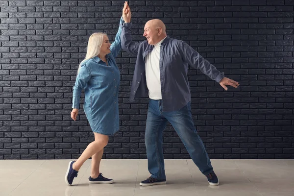 Cute Elderly Couple Dancing Dark Brick Wall — Stock Photo, Image