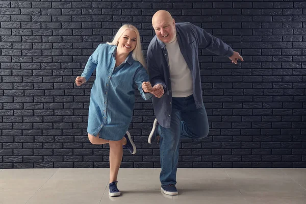 Cute Elderly Couple Dancing Dark Brick Wall — Stock Photo, Image