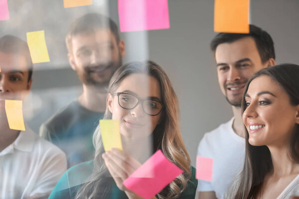 View at business team during meeting in office through transparent board